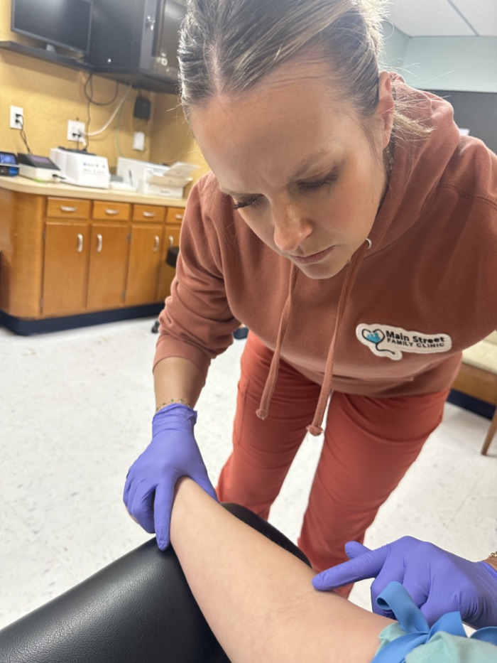 A provider caring for a patient in the exam room